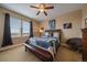 Comfortable bedroom with ceiling fan, large window, and tastefully decorated with framed art pieces at 7635 Weaver Cir, Castle Rock, CO 80104