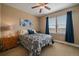 Cozy bedroom featuring a comfortable bed, a large window, and soft blue decor at 7635 Weaver Cir, Castle Rock, CO 80104