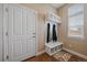 Inviting entryway featuring a convenient built-in bench with coat hooks and storage at 7635 Weaver Cir, Castle Rock, CO 80104