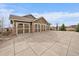 Three-car garage and large concrete driveway with basketball hoop at 7635 Weaver Cir, Castle Rock, CO 80104