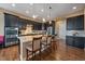 Gourmet kitchen featuring dark cabinetry, stainless steel appliances, granite countertops, and a convenient center island at 7635 Weaver Cir, Castle Rock, CO 80104