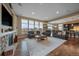 Bright and spacious living room with hardwood floors, stone fireplace, and large windows with beautiful views at 7635 Weaver Cir, Castle Rock, CO 80104