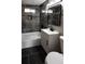 Modern bathroom with gray tile, a white vanity, and a bathtub at 1568 Verbena St, Denver, CO 80220