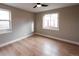 Bright bedroom with hardwood floors, two windows, and neutral paint at 1568 Verbena St, Denver, CO 80220