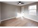 Bright bedroom with hardwood floors, a ceiling fan, and a window at 1568 Verbena St, Denver, CO 80220