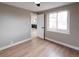 Sunlit bedroom showcasing updated floors and a window bringing in natural light at 1568 Verbena St, Denver, CO 80220