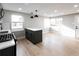 Kitchen boasts an island, sleek pendant lighting, stainless steel stove and an open, airy layout at 1568 Verbena St, Denver, CO 80220