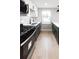 Modern kitchen offers a black gas range and forest green cabinets at 1568 Verbena St, Denver, CO 80220