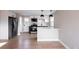 Stylish kitchen features stainless steel appliances, white cabinets and an island breakfast bar at 1568 Verbena St, Denver, CO 80220