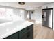 Bright kitchen features stainless steel refrigerator, white countertops and modern cabinets at 1568 Verbena St, Denver, CO 80220