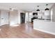 Modern kitchen with stainless steel appliances, white cabinetry, and wood floors at 1568 Verbena St, Denver, CO 80220
