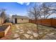 Backyard featuring garden beds, a storage shed, and a new wood fence at 3196 S Logan St, Englewood, CO 80113