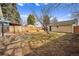 Backyard featuring stone patio with garden beds and a new wood fence at 3196 S Logan St, Englewood, CO 80113