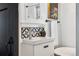 Bright bathroom featuring a modern vanity with black and white geometric tile and a clawfoot tub at 3196 S Logan St, Englewood, CO 80113