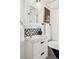 Charming bathroom featuring a modern vanity with a geometric tile backsplash and black trim at 3196 S Logan St, Englewood, CO 80113