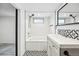Updated bathroom with a tub, vanity, subway tile, and patterned tile flooring at 3196 S Logan St, Englewood, CO 80113
