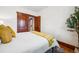 Bright bedroom featuring hardwood floors and bi-fold closet doors at 3196 S Logan St, Englewood, CO 80113
