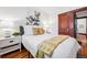 Bright bedroom featuring hardwood floors and a modern art piece on the wall at 3196 S Logan St, Englewood, CO 80113