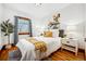 Comfortable bedroom featuring hardwood floors, soft natural light, and stylish contemporary decor at 3196 S Logan St, Englewood, CO 80113