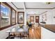 Bright dining area with wood floors, trim and large windows open to the living room at 3196 S Logan St, Englewood, CO 80113