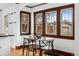 Cozy dining area with a wooden table, chair set, and large windows providing ample light at 3196 S Logan St, Englewood, CO 80113
