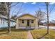 Charming yellow home with a well-maintained front yard and inviting curb appeal at 3196 S Logan St, Englewood, CO 80113