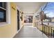 Inviting front porch with classic railing detail and a bright, sunny yellow exterior at 3196 S Logan St, Englewood, CO 80113