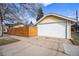 Detached garage with a new white door and private new wood fence at 3196 S Logan St, Englewood, CO 80113