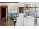 Modern kitchen with black countertops, white cabinets, and decorative backsplash at 3196 S Logan St, Englewood, CO 80113