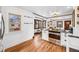 Bright kitchen featuring an open layout, wood floors, and easy access to dining area at 3196 S Logan St, Englewood, CO 80113