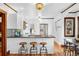 Well-lit kitchen featuring white cabinets, stainless steel appliances, and black countertops at 3196 S Logan St, Englewood, CO 80113