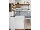 Farmhouse style kitchen sink with stainless steel dishwasher, modern faucet and floating shelves at 3196 S Logan St, Englewood, CO 80113
