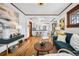 Open living room leading to the kitchen, featuring hardwood floors and modern design at 3196 S Logan St, Englewood, CO 80113