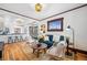 Spacious living room open to the kitchen, featuring hardwood floors and stylish decor at 3196 S Logan St, Englewood, CO 80113
