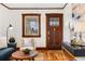 Cozy living room showcasing stylish furnishings, hardwood floors, and a beautifully crafted wooden door at 3196 S Logan St, Englewood, CO 80113