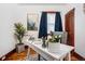 Bright home office with a white desk, stylish decor, hardwood floors, and natural light at 3196 S Logan St, Englewood, CO 80113