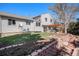Beautiful backyard with patio area, new landscaping and a brick walkway at 7852 S Logan St, Littleton, CO 80122