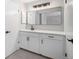 Modern bathroom with dual sinks, quartz countertop, ample storage, and contemporary lighting at 7852 S Logan St, Littleton, CO 80122