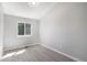 Neutral bedroom with a single window allowing natural light and wood-look flooring at 7852 S Logan St, Littleton, CO 80122