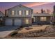 Charming two-story home with a brick and siding exterior, a two-car garage, and a well-maintained front yard at 7852 S Logan St, Littleton, CO 80122