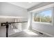 Upstairs hallway with view of fireplace and large window providing lots of natural light at 7852 S Logan St, Littleton, CO 80122