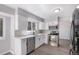 Modern kitchen with white cabinets, stainless steel appliances, and a view of the backyard at 7852 S Logan St, Littleton, CO 80122