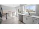 Bright modern kitchen with stainless dishwasher, sink, and faucet, plus view of the living room at 7852 S Logan St, Littleton, CO 80122