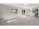 Bright living room with walk out access to a large backyard patio and kitchen access at 7852 S Logan St, Littleton, CO 80122