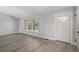 Bright living room with wood floors and a large window with a view of the outdoors at 7852 S Logan St, Littleton, CO 80122