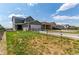 Spacious backyard with a wooden fence, grass and an attached two-car garage at 9862 Reunion Pkwy, Commerce City, CO 80022