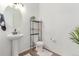 Cozy bathroom featuring pedestal sink, decorative shelving, and modern fixtures at 9862 Reunion Pkwy, Commerce City, CO 80022