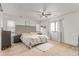 Spacious bedroom with ceiling fan, natural light, and carpet flooring at 9862 Reunion Pkwy, Commerce City, CO 80022