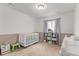 Bedroom with crib, changing table, stuffed animal decor, and neutral carpeting at 9862 Reunion Pkwy, Commerce City, CO 80022