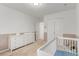 Bedroom with changing table, crib, and neutral carpeting at 9862 Reunion Pkwy, Commerce City, CO 80022